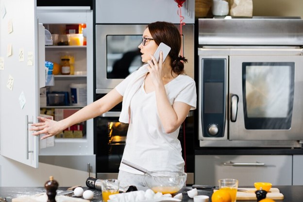 Woman on phone expressing concern about kitchen germs